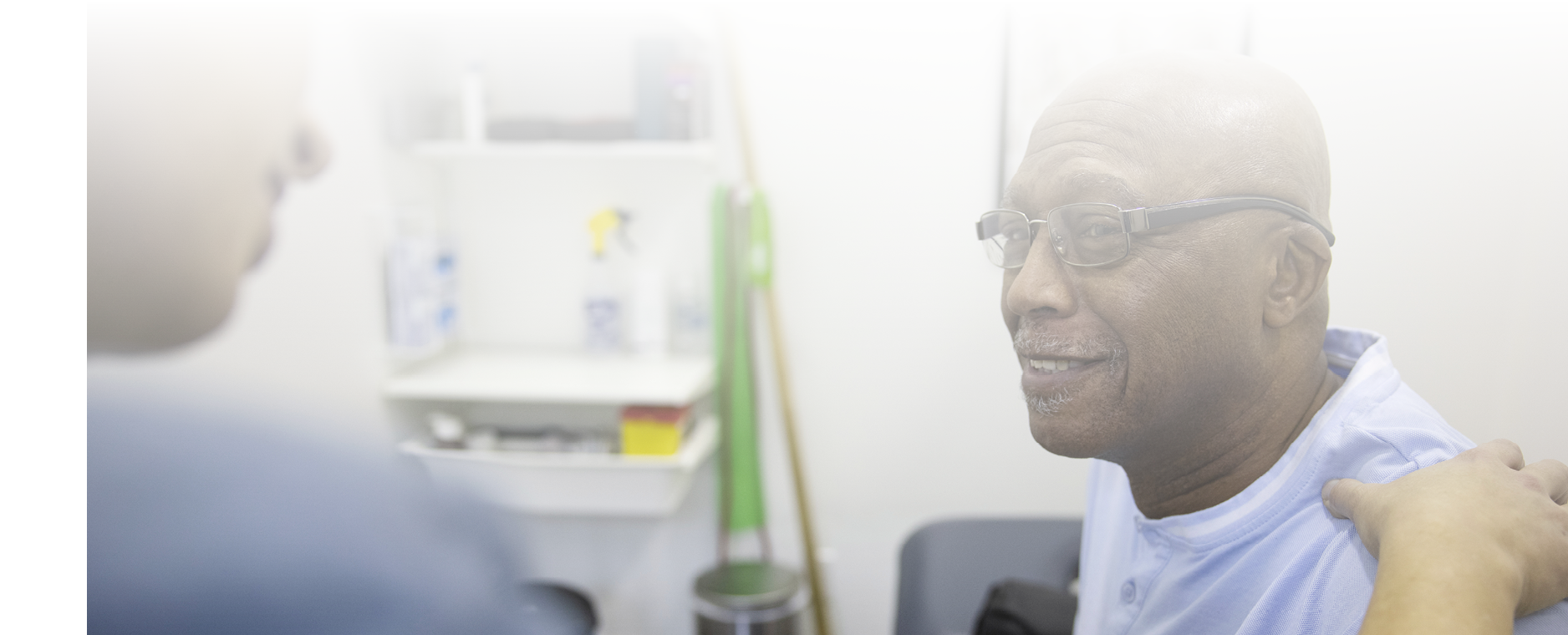 Doctor talking with senior patient in exam room