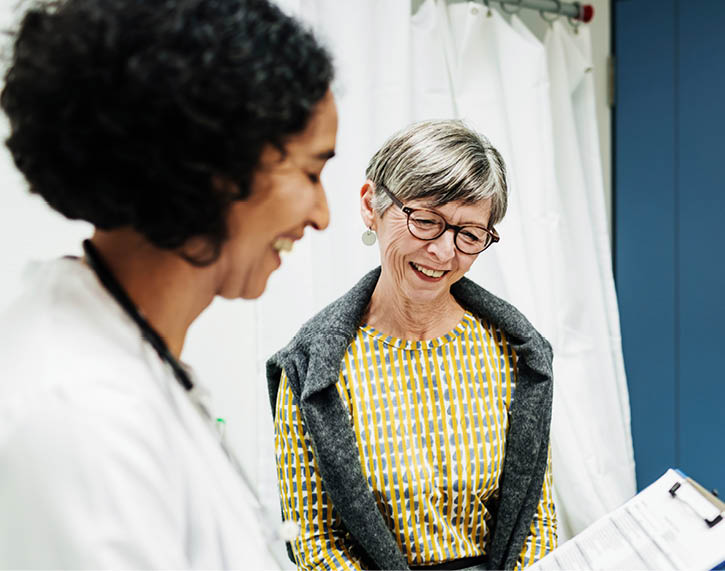 Doctor going over test results with senior female patient