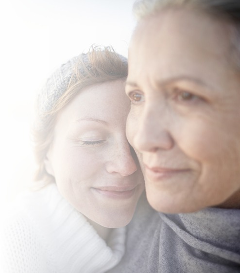 Mother and adult daughter on beach